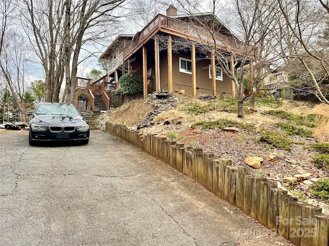 9009 Cebu Ct, Fort Mill, SC 29708 - view of side of property featuring a deck, fence, crawl space, stairway, and a chimney