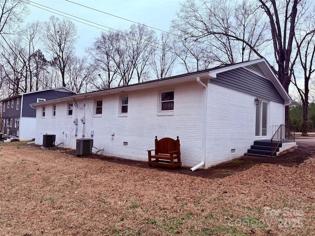 rear view of property with central AC unit