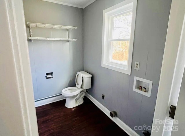 bathroom with hardwood / wood-style flooring, baseboard heating, and toilet