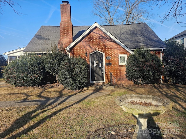 back of house with a lawn