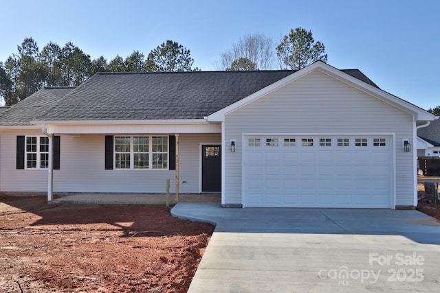 ranch-style house featuring an attached garage, concrete driveway, and roof with shingles