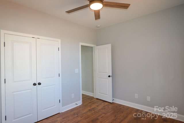 unfurnished bedroom with ceiling fan, a closet, wood finished floors, and baseboards