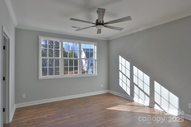 empty room featuring a ceiling fan, dark wood-style flooring, crown molding, and baseboards