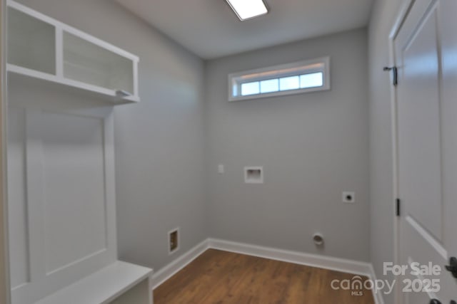 laundry area featuring dark wood-style flooring, hookup for a washing machine, electric dryer hookup, laundry area, and baseboards