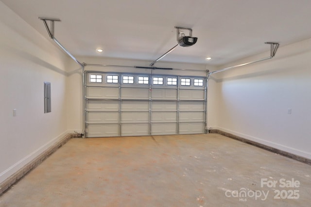 garage with a garage door opener and baseboards