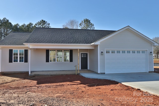 ranch-style home featuring a shingled roof, concrete driveway, and an attached garage