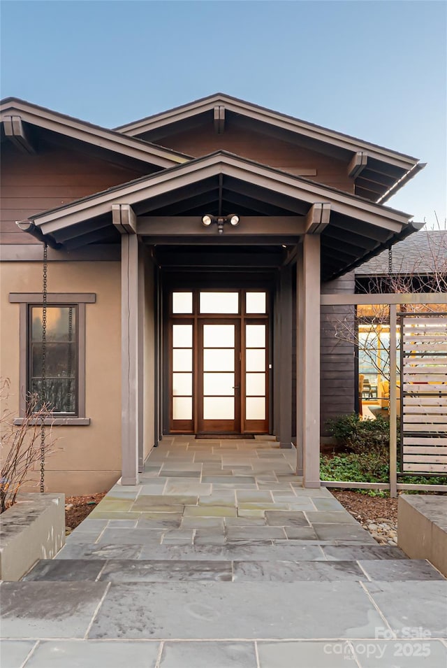 entrance to property with stucco siding