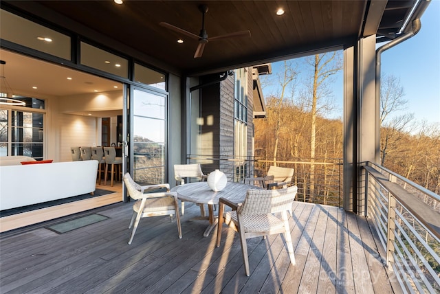 wooden deck with a ceiling fan