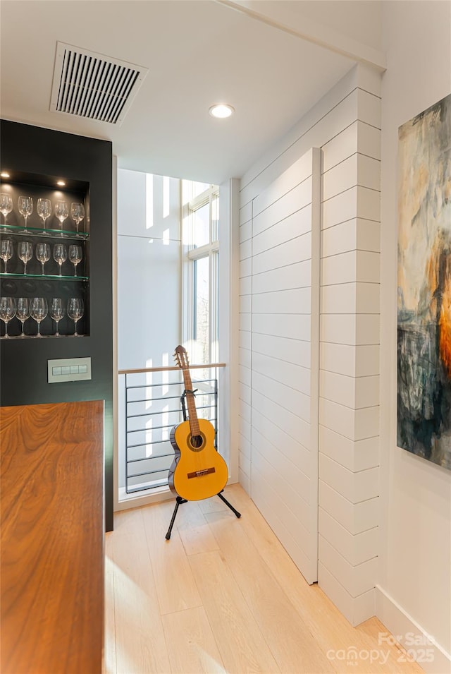 interior space with wood finished floors and visible vents