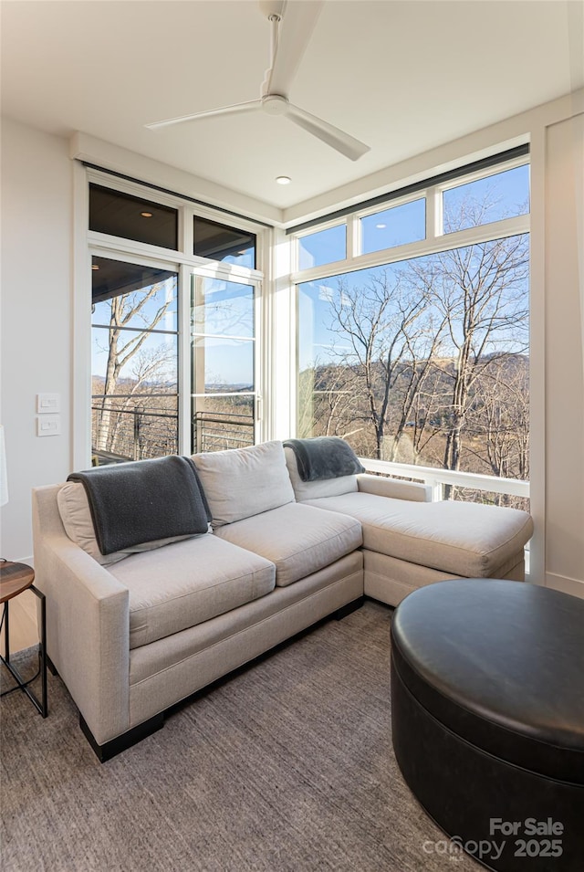 sunroom with a ceiling fan and a wealth of natural light