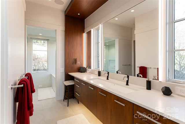 full bath with tile patterned flooring, vanity, a wealth of natural light, and recessed lighting