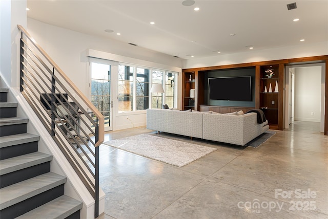 unfurnished living room with recessed lighting, visible vents, finished concrete floors, baseboards, and stairs