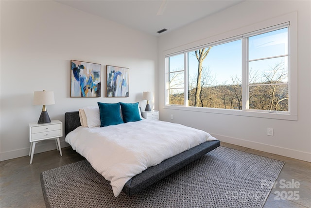 bedroom featuring baseboards and visible vents