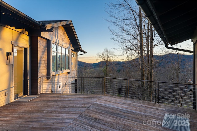 wooden deck with a mountain view