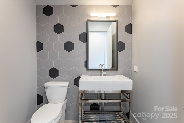1121 Timberbluff Way, Arden, NC 28704 - half bathroom featuring tile walls, toilet, and a sink