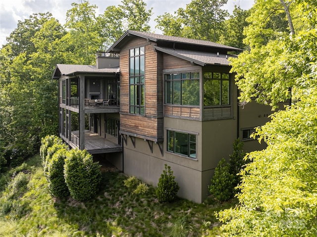 1121 Timberbluff Way, Arden, NC 28704 - view of property exterior with a sunroom, a wooden deck, and stucco siding