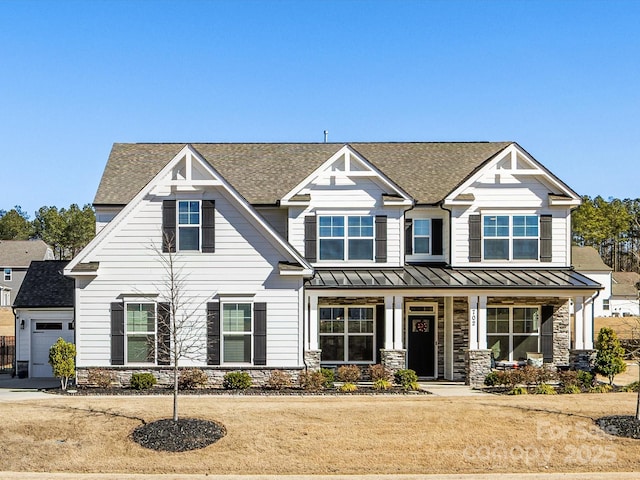 craftsman inspired home featuring a front lawn, a garage, and a porch