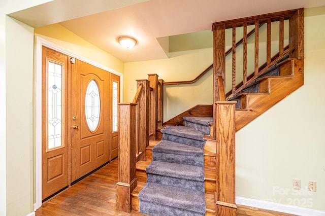 entryway with stairs and wood finished floors