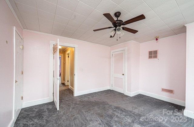 unfurnished bedroom with ornamental molding, carpet flooring, and visible vents