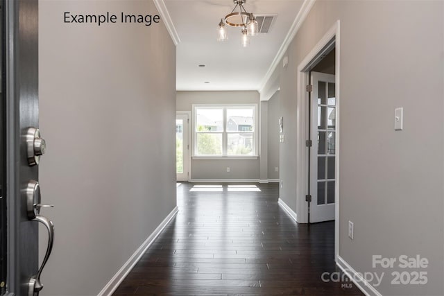 hall with ornamental molding, baseboards, and dark wood-style flooring
