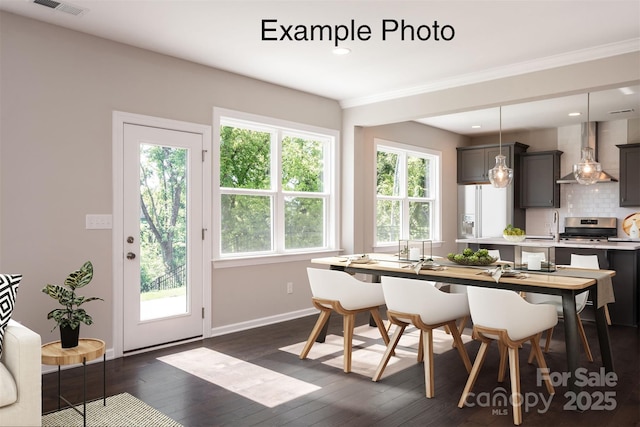dining space featuring dark wood finished floors, baseboards, recessed lighting, and crown molding