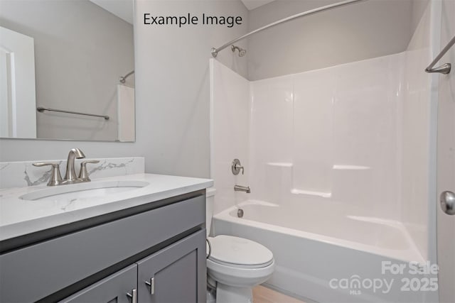 bathroom with toilet, vanity, and bathtub / shower combination