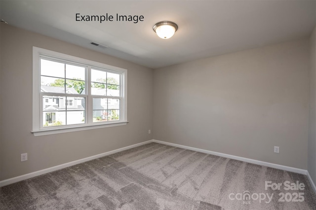carpeted empty room with baseboards