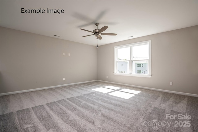 carpeted spare room with ceiling fan and baseboards