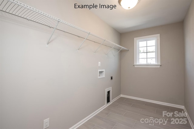 clothes washing area featuring hookup for an electric dryer, washer hookup, and baseboards