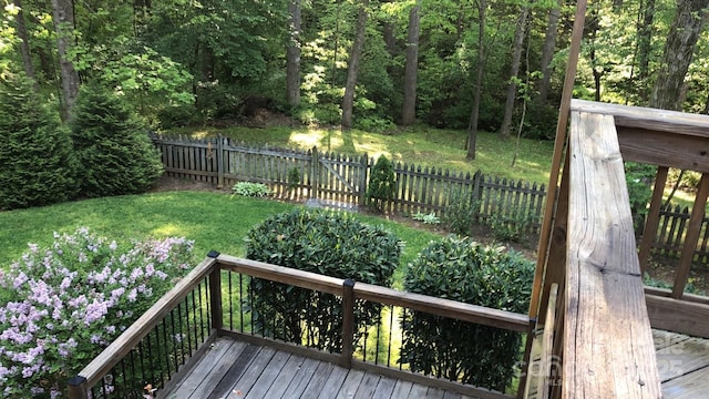 wooden terrace with fence and a lawn