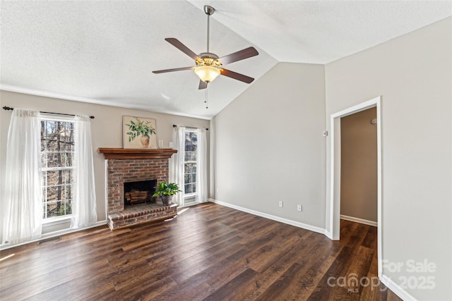 unfurnished living room featuring ceiling fan, wood finished floors, visible vents, vaulted ceiling, and a brick fireplace