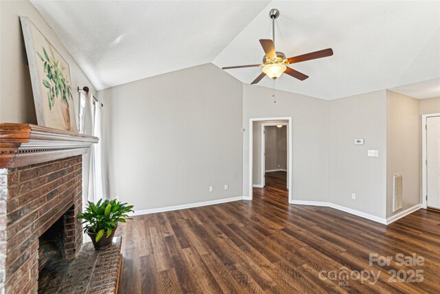 unfurnished living room featuring lofted ceiling, wood finished floors, visible vents, baseboards, and a brick fireplace