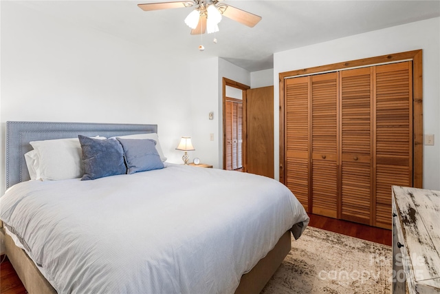 bedroom featuring ceiling fan, a closet, and wood finished floors