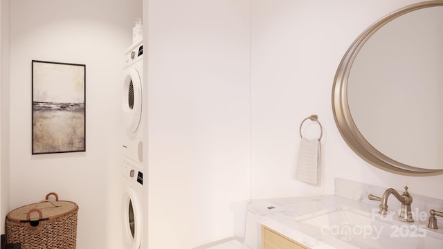 bathroom featuring vanity and stacked washer / dryer