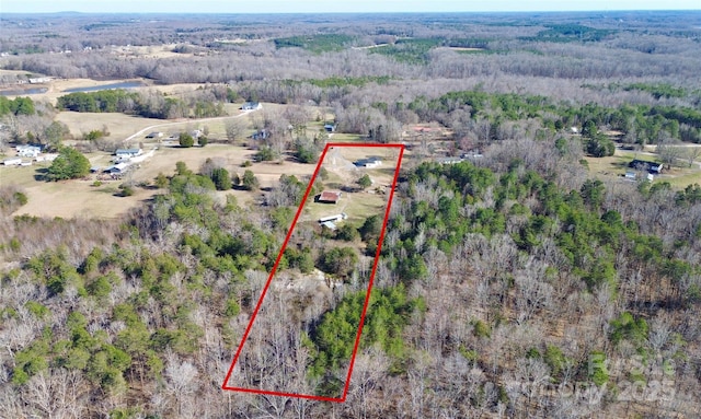 bird's eye view featuring a wooded view