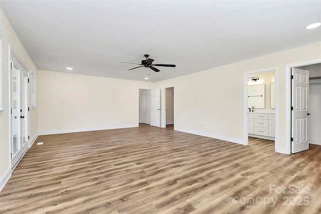 unfurnished bedroom featuring ceiling fan, connected bathroom, recessed lighting, baseboards, and light wood-style floors