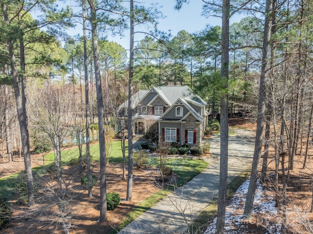 view of front of house featuring stone siding and concrete driveway