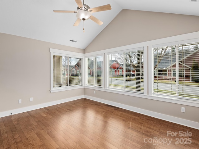 empty room featuring ceiling fan, wood-type flooring, and high vaulted ceiling