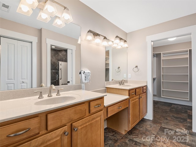 bathroom with walk in shower and vanity