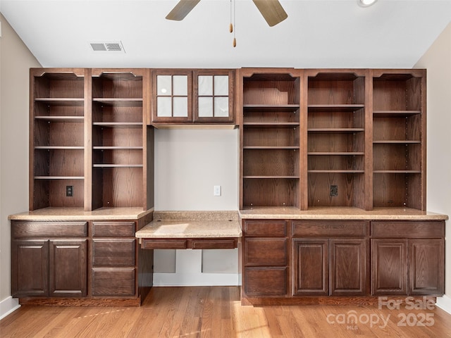 unfurnished office featuring ceiling fan and light hardwood / wood-style flooring