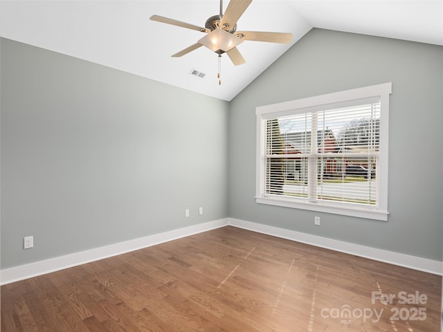 unfurnished room with ceiling fan, hardwood / wood-style floors, and vaulted ceiling