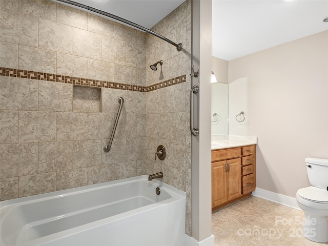 full bathroom featuring toilet, tiled shower / bath, tile patterned flooring, and vanity