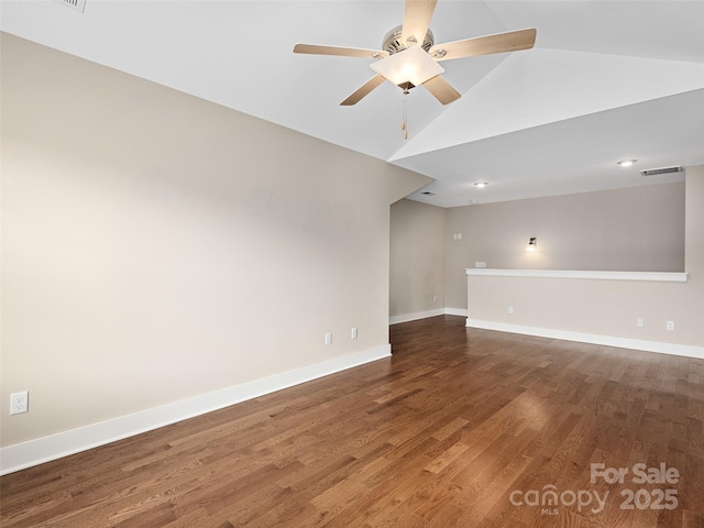 unfurnished room with ceiling fan, hardwood / wood-style floors, and vaulted ceiling