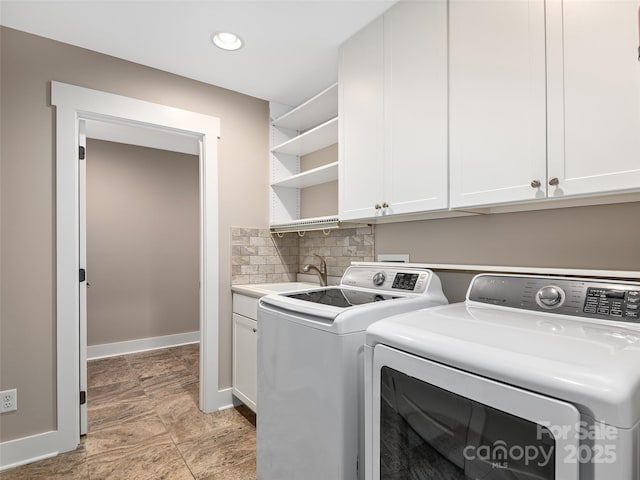 laundry area featuring sink, cabinets, and separate washer and dryer