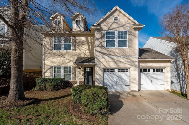 traditional home featuring a garage and driveway