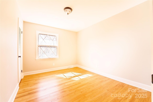 unfurnished room with hardwood / wood-style floors