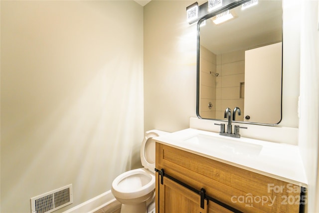 bathroom featuring toilet and vanity