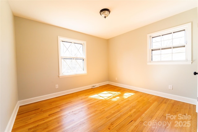 spare room featuring hardwood / wood-style floors