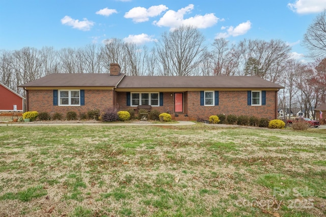 single story home featuring brick siding, a chimney, and a front lawn