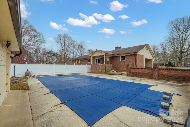 view of swimming pool with a fenced backyard, a fenced in pool, and a patio